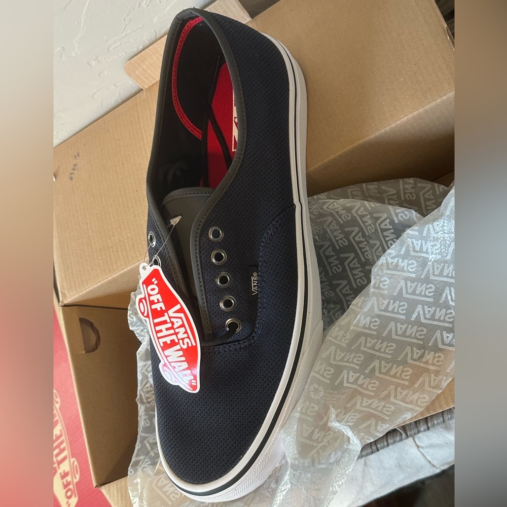 Men’s size 13 vans. New in original box. Dress blue with grey tongue.